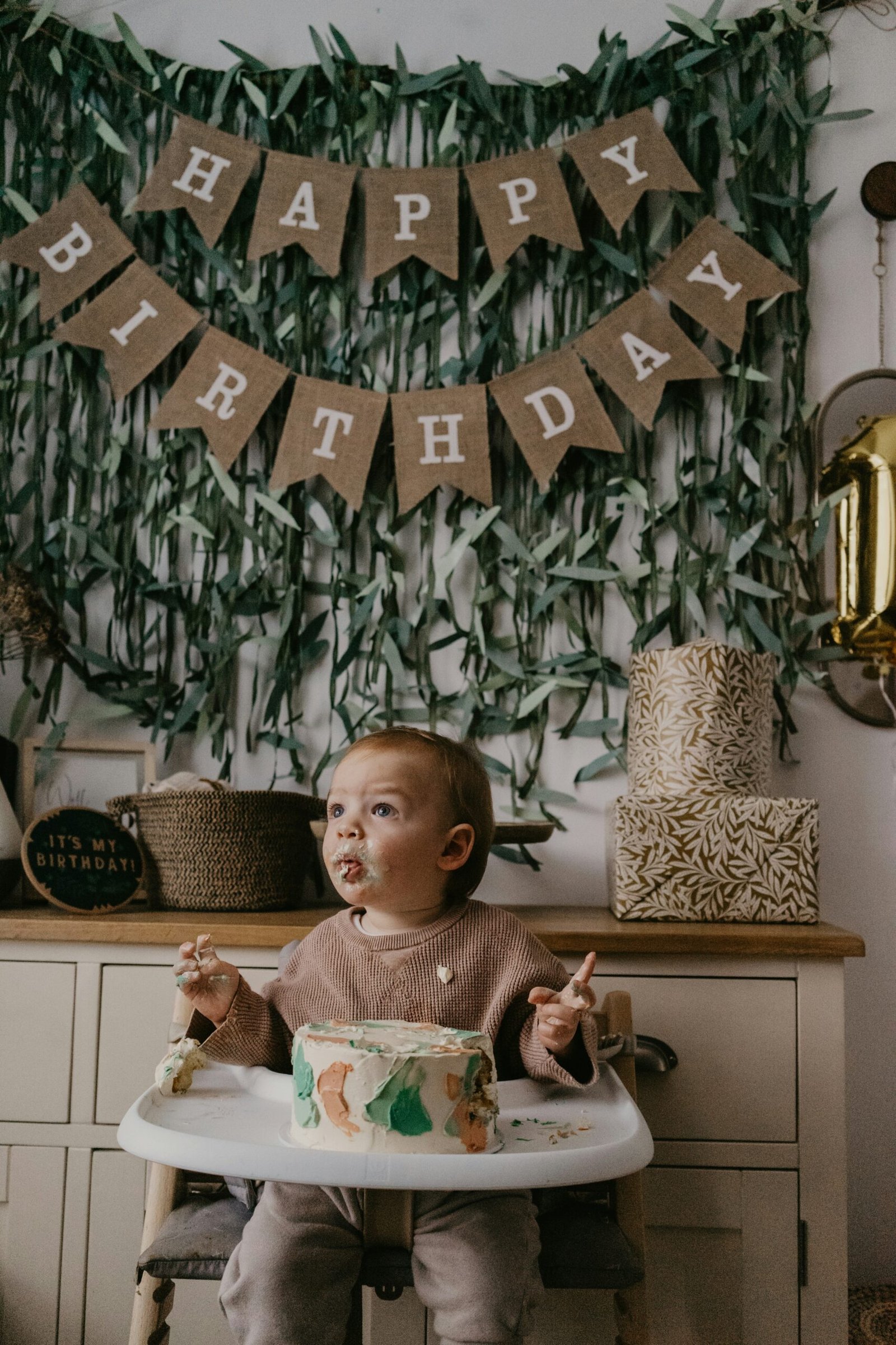 Baby sitting in a full-size high chair at a dining table